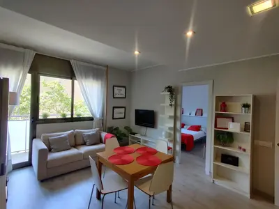 a living room with a table and a couch at Fira Plaza España apartment in Barcelona