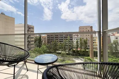 a balcony with two chairs and a glass table at ChicStays Apartment Vila Olímpica in Barcelona