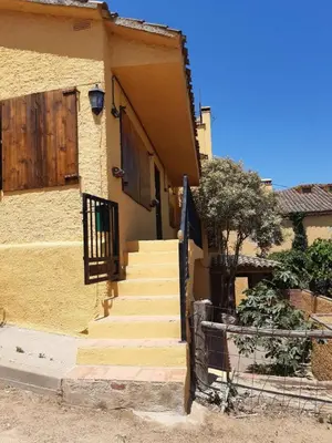 a house with stairs leading up to a door at Apartamentos Can bruguera 3 in Mataró