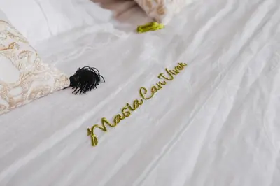 a bed with a happy anniversary written on it at Masia Can Viver - Olive oil tourism B&B in Bigues i Riells