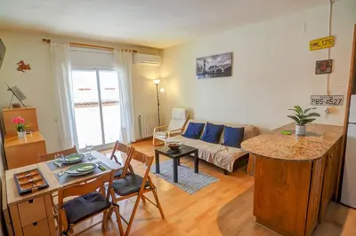 a living room with a couch and a table at Hermione Apartment by Hello Homes Sitges in Sitges