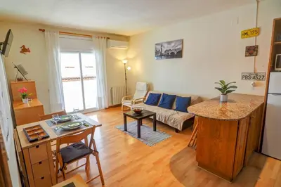 a living room with a couch and a table at Hermione Apartment by Hello Homes Sitges in Sitges