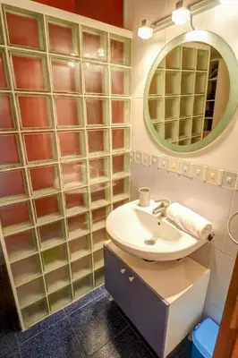 a bathroom with a sink and a mirror at Hermione Apartment by Hello Homes Sitges in Sitges