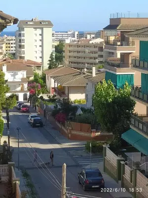 a city street with cars parked on the road at Apartamento Bella Carmen : para 6 personas in Cunit