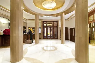 a lobby with columns and a circular ceiling at Hotel Astoria in Barcelona