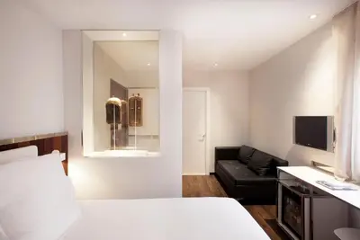 a bathroom with a sink and a toilet and a tub at Hotel Balmes, a member of Preferred Hotels & Resorts in Barcelona