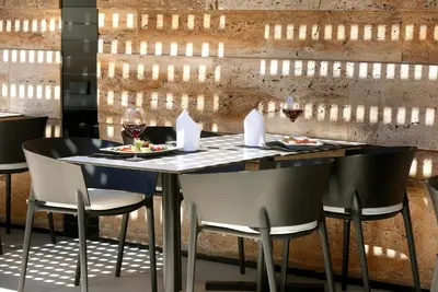 a dining room with a table with glasses of wine at HCC St. Moritz in Barcelona