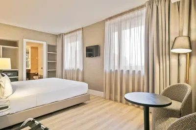 a bedroom with a bed and a table and chairs at Acta CITY47 in Barcelona