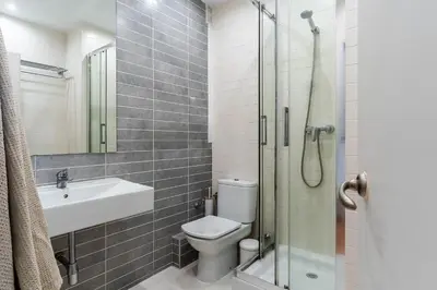 a bathroom with a toilet and a sink and a shower at Canela Homes BARCELONA CASP in Barcelona