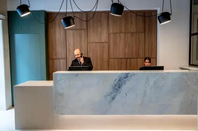two people sitting at a table with their laptops at Grupotel Gravina in Barcelona