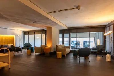 a lobby with couches and chairs in a building at Onix Fira in Barcelona