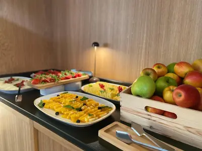 a buffet with several plates of food on a table at Onix Fira in Barcelona