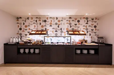 a food counter in a room with food on it at Eurostars Cristal Palace in Barcelona