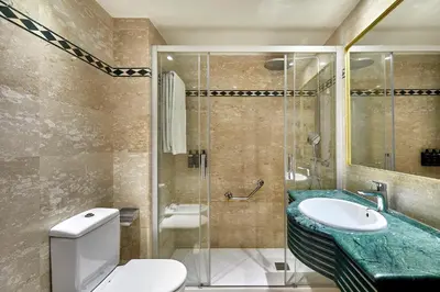 a bathroom with a shower and a toilet and a sink at Exe Mitre in Barcelona