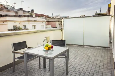 a bowl of fruit on a table on a roof at Zenit Barcelona in Barcelona