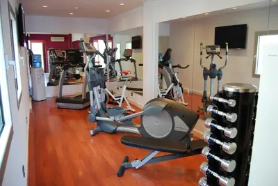 a gym with treadmills and elliptical machines at Zenit Barcelona in Barcelona