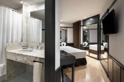 a bathroom with a large sink and a large mirror at Hotel Punt 14 in Gavà