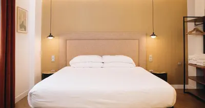 a bedroom with a large white bed with two pillows at H La Paloma Boutique in Barcelona