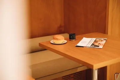 a hat sitting on a table with a cup and a magazine at H La Paloma Boutique in Barcelona