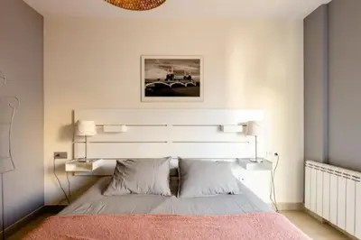 a bedroom with a bed with a large white headboard at Apt.p/5 15min from Barcelona and Beaches W/Terrace in Sant Adria de Besos