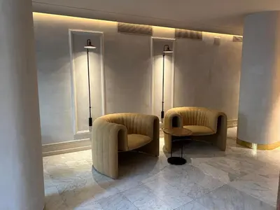 a lobby with two chairs and a table and lights at Caledonian in Barcelona