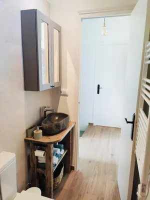 a bathroom with a sink and a toilet at Cozy place, big roof terrace & spectacular views. in Cabrils