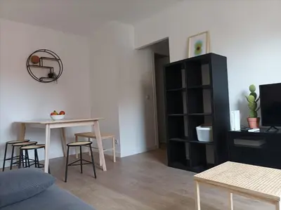 a living room with a table and a black book shelf at COOL! 5' to metro. 15' to Center/beach by metro. in Santa Coloma de Gramanet
