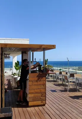 a deck with several chairs and tables on a roof at Eurohotel Diagonal Port in Barcelona