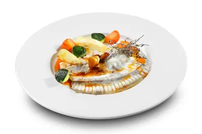 a plate of food with seafood on a white plate at HCC Montblanc in Barcelona