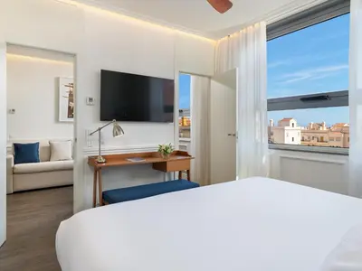 a hotel room with a bed and a television at H10 Itaca in Barcelona