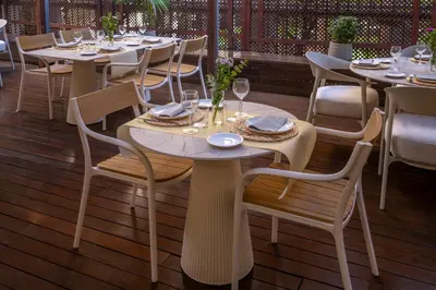 a restaurant with tables and chairs on a deck at Hotel SERHS Rivoli Rambla in Barcelona