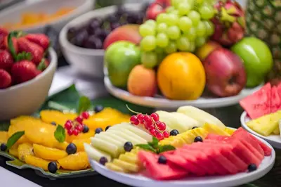 a table topped with plates of fruits and vegetables at Hotel SERHS Rivoli Rambla in Barcelona
