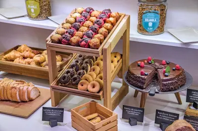 a bakery with different types of pastries and bread at Hotel SERHS Rivoli Rambla in Barcelona