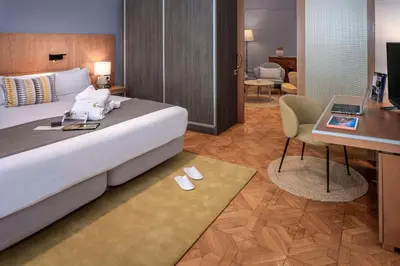 a hotel room with a bed and a desk and a desk at Hotel SERHS Rivoli Rambla in Barcelona