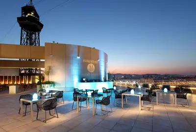 a group of tables and chairs on a patio at Eurostars Grand Marina Hotel GL in Barcelona