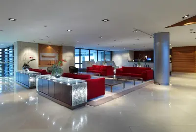 a living room with red furniture in a building at Eurostars Grand Marina Hotel GL in Barcelona