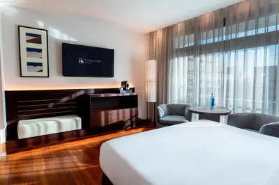 a hotel room with a bed and a flat screen tv at Eurostars Grand Marina Hotel GL in Barcelona