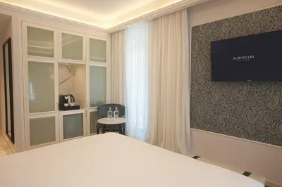 a bedroom with a bed and a television on a wall at Eurostars Laietana in Barcelona