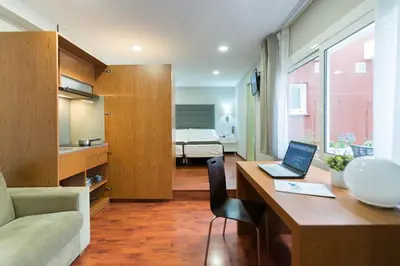 a room with a desk with a laptop on it at Senator Barcelona Apartments in Barcelona