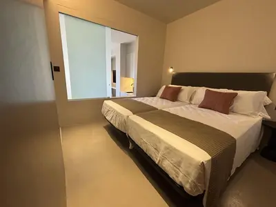 a bedroom with a large bed with a large window at Senator Barcelona Apartments in Barcelona