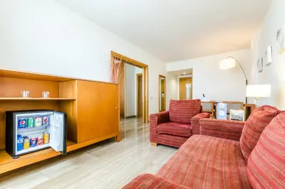 a living room with a couch and a tv at Exe Barbera Parc in Barbera del Valles