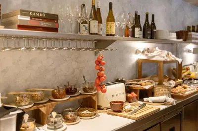 a kitchen with a counter with food and wine bottles at Hotel Casa Teva Barcelona in Barcelona