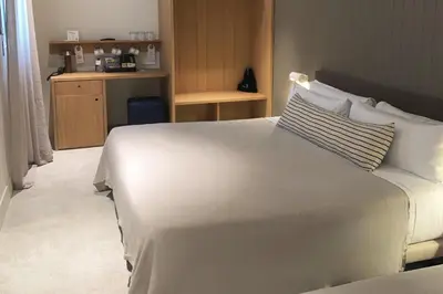 a hotel room with a large white bed with pillows at Hotel Casa Teva Barcelona in Barcelona