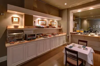 a kitchen with a counter and a table in a restaurant at Hotel Condado in Barcelona