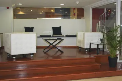 a lobby with two white chairs and a table at Hotel Abbot in Barcelona