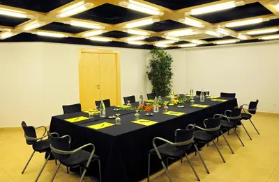 a conference room with a long black table and chairs at Hotel Abbot in Barcelona