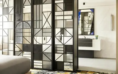 a bedroom with a glass door leading to a bathroom at Grand Hyatt Barcelona in Barcelona