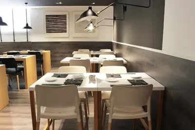 a dining room with tables and chairs in a restaurant at Paral·lel in Barcelona