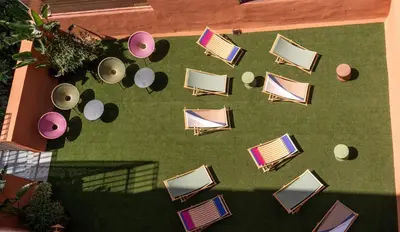an overhead view of chairs and tables on a lawn at htop BCN City #htopEnjoy in Barcelona