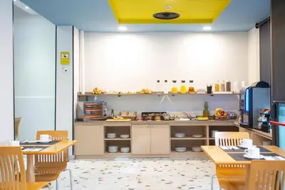 a kitchen with wooden tables and chairs and a counter at Casual Colours Barcelona in Barcelona